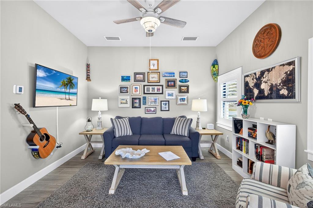 Living area featuring wood finished floors and a ceiling fan