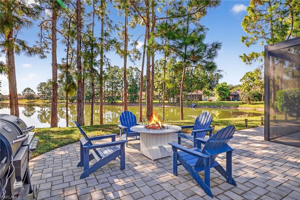 View of patio / terrace featuring a grill, a water view, and a fire pit