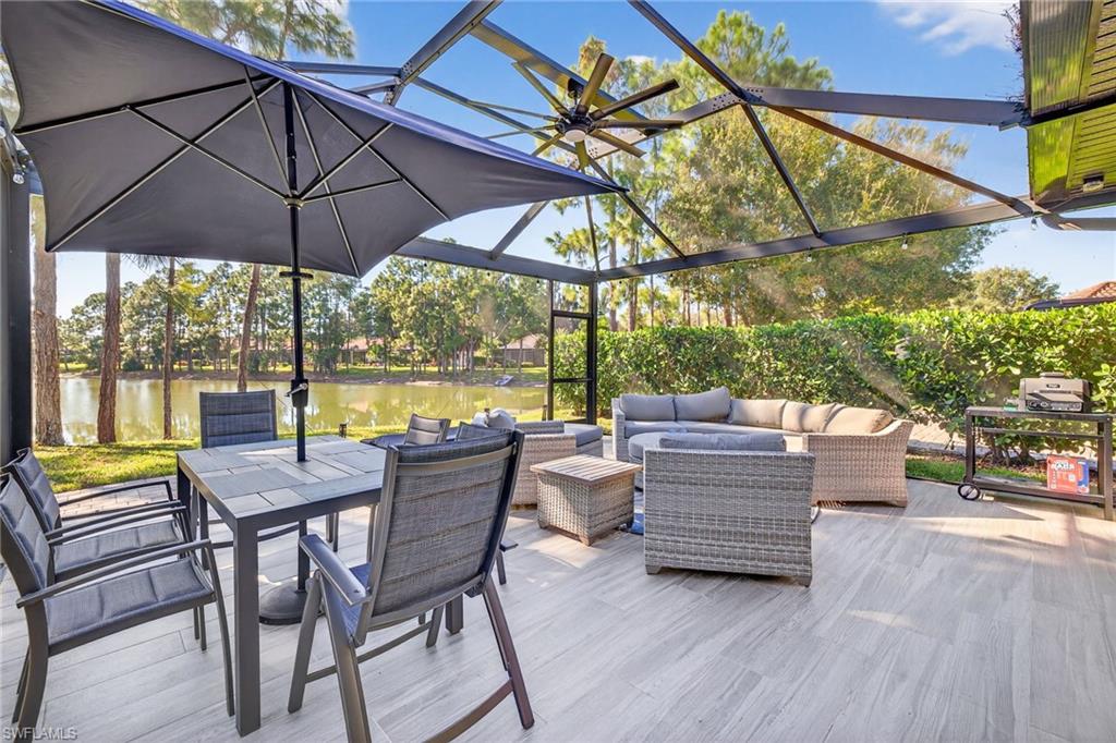 View of patio with outdoor lounge area, outdoor dining space, a sunroom, and a water view