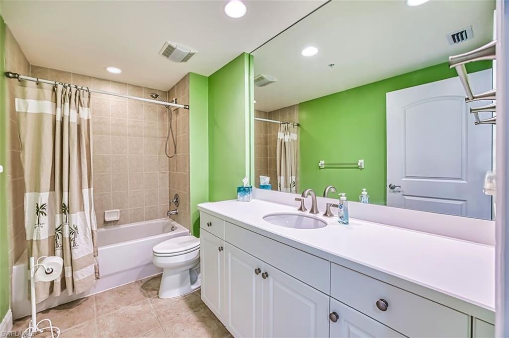 Full bath featuring vanity, shower / bath combination with curtain, and recessed lighting