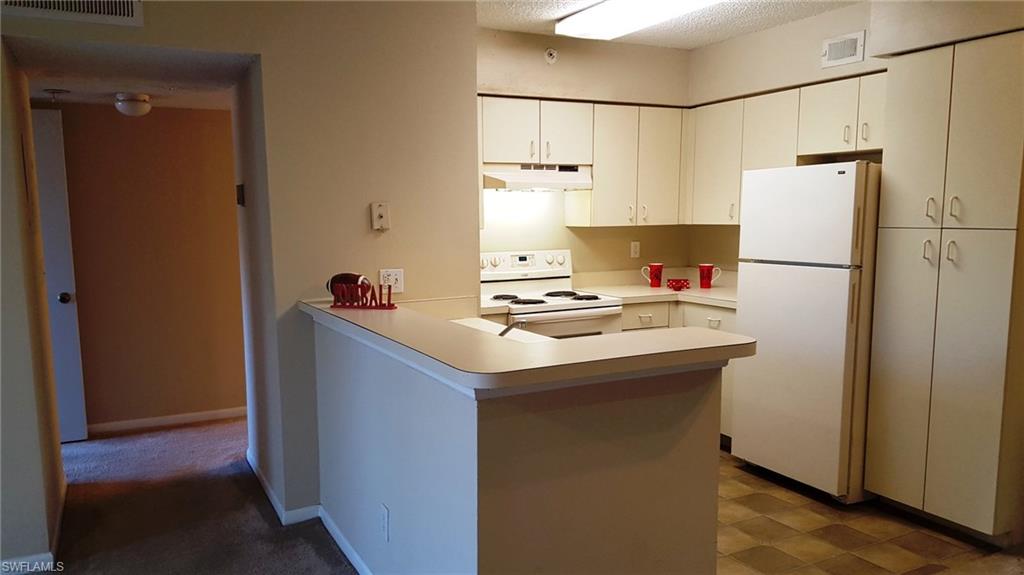 Flooring in hall and kitchen has been replaced with the light wood look tile.
