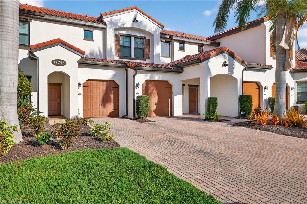 Mediterranean / spanish home featuring stucco siding and a tile roof