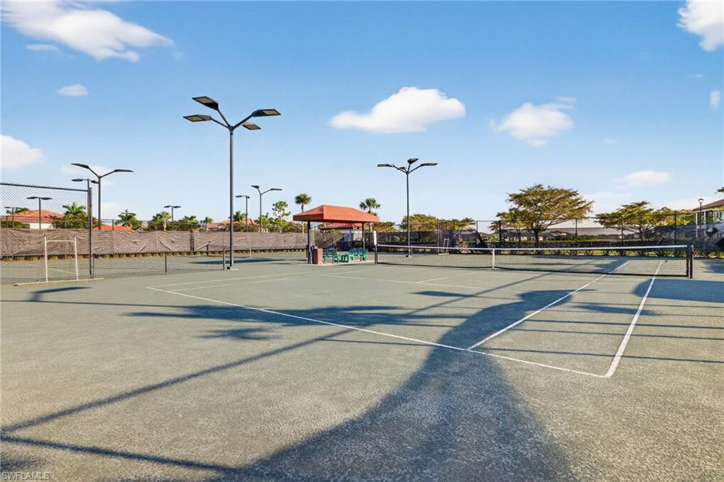 View of tennis court featuring community basketball court
