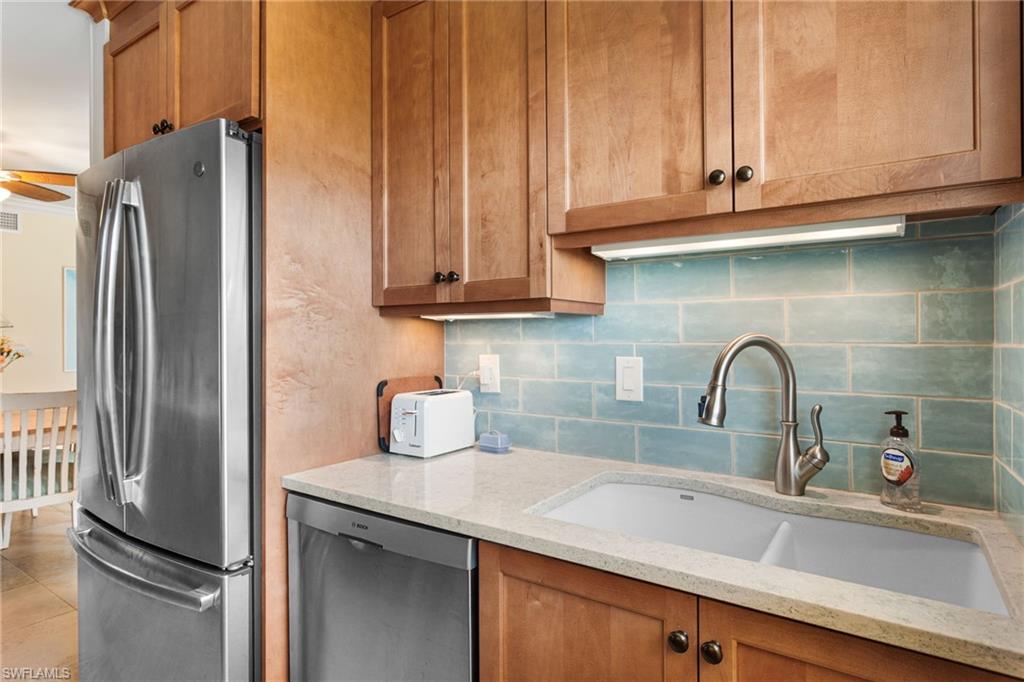 Quartz counters, stainless appliances, rich wood cabinetry, subway tile backsplash!