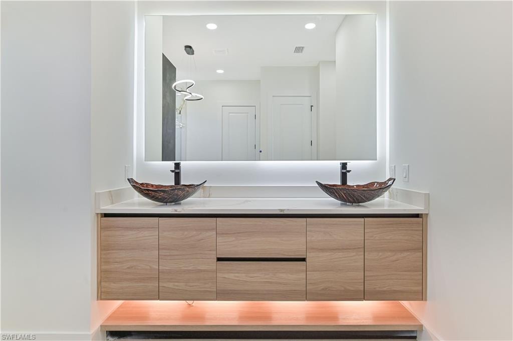 Full bathroom featuring double vanity and recessed lighting