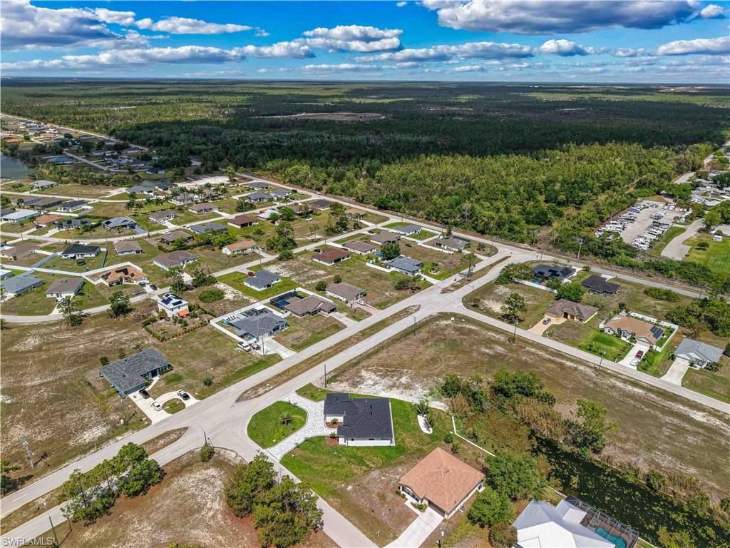 Aerial view of residential area featuring a heavily wooded area