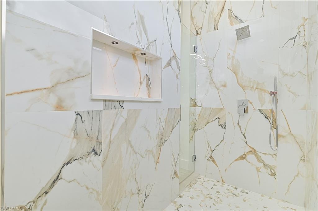 Bathroom featuring a marble finish shower