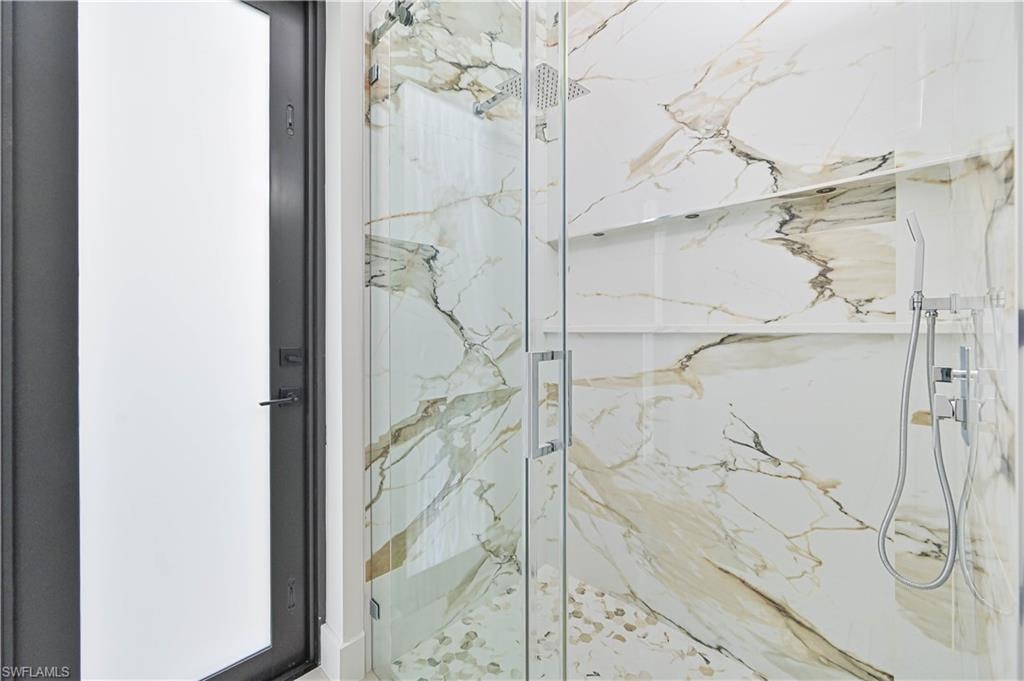 Bathroom with a marble finish shower