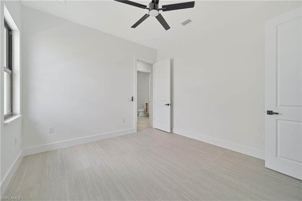 Unfurnished bedroom with a ceiling fan and baseboards