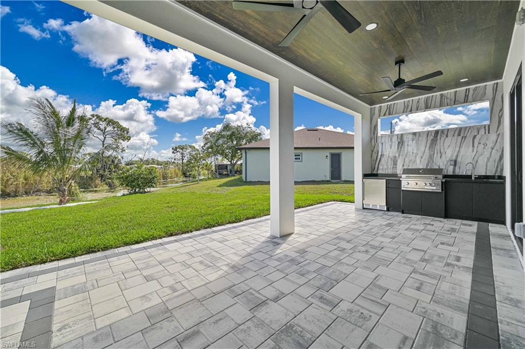 View of patio featuring an outdoor kitchen and a ceiling fan