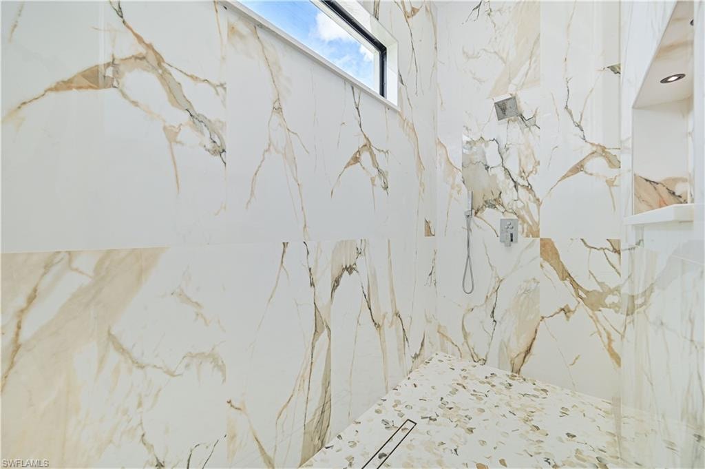 Bathroom view of a marble finish shower