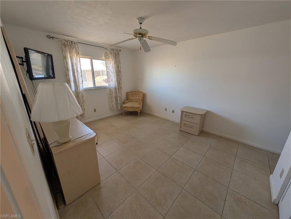 Guest bedroom with a dresser, nightstand, chair and Television.  Just bring your bed.