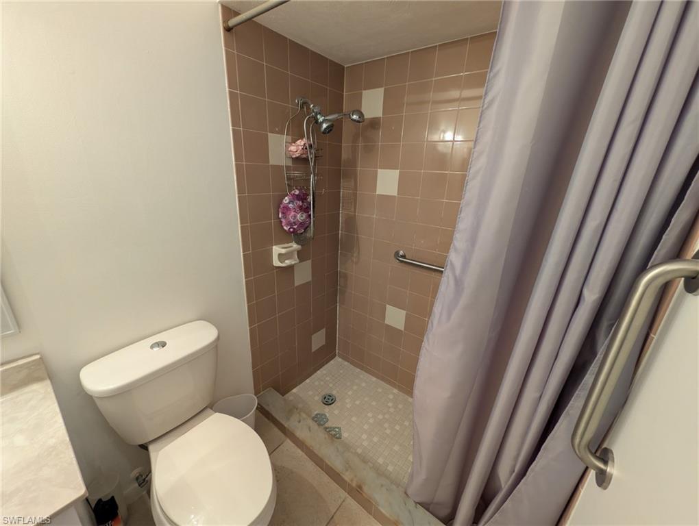 Full bath with a shower stall and vanity