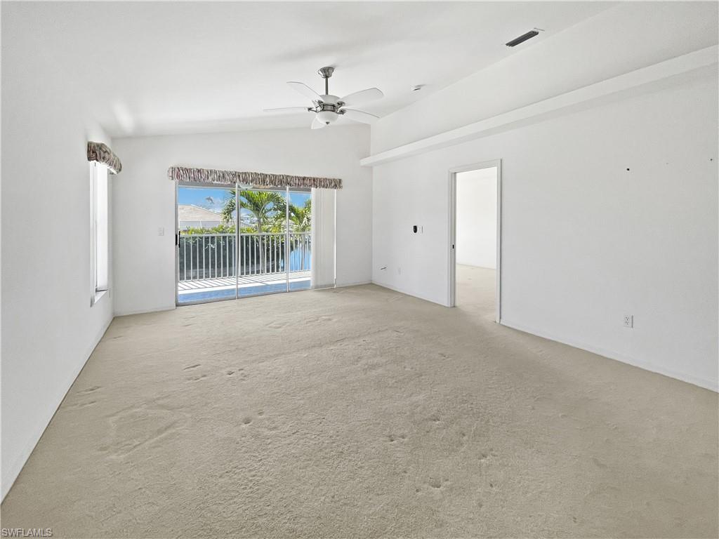 Living/Family room featuring carpet floors, vaulted ceiling, and ceiling fan