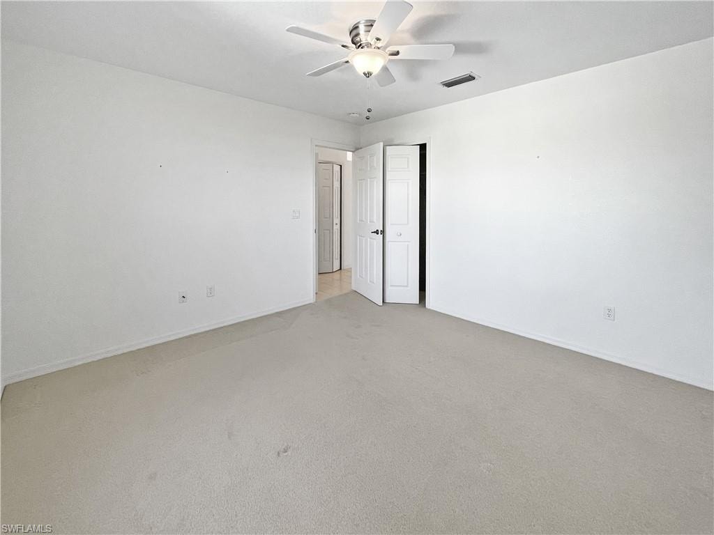Guest bedroom with carpet flooring and ceiling fan