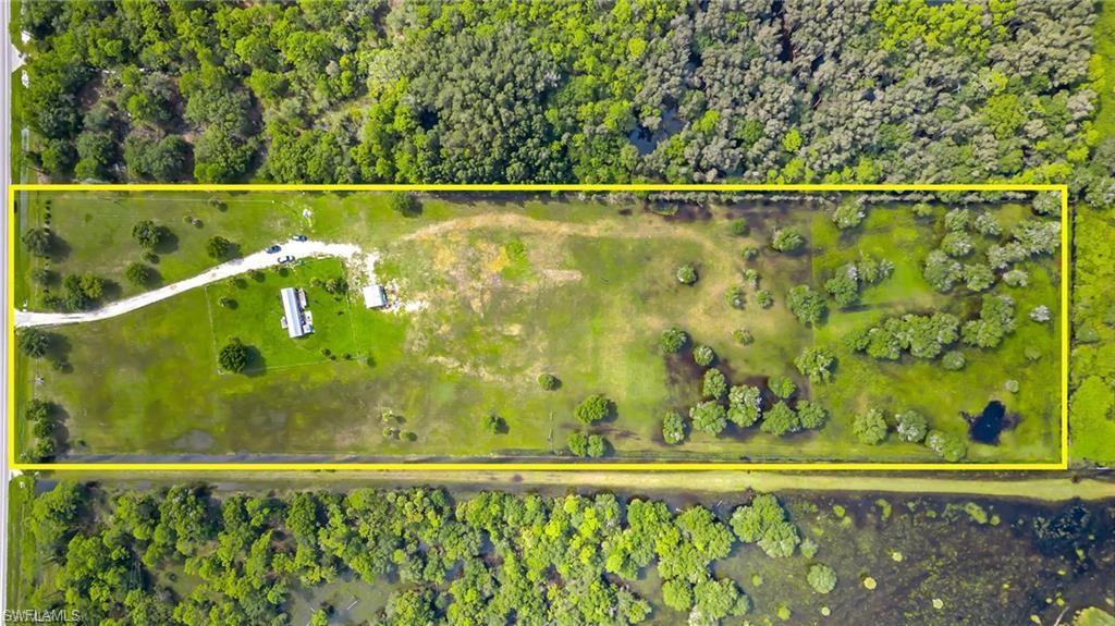 View of property location with property parcel outlined and a heavily wooded area