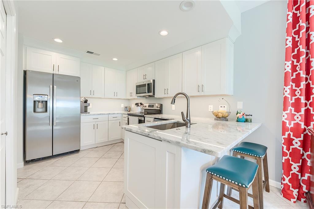 NEW SHAKER CABINETRY WITH QUARTZ COUNTERTOPS, NEW LIGHTING AND NEW PLUMBING FIXTURES, AND STAINLESS STEEL APPLIANCES