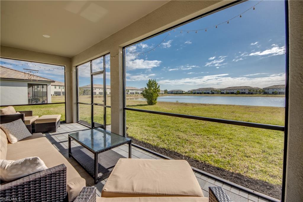 Sunroom / solarium featuring an outdoor living space, a residential view, and a water view