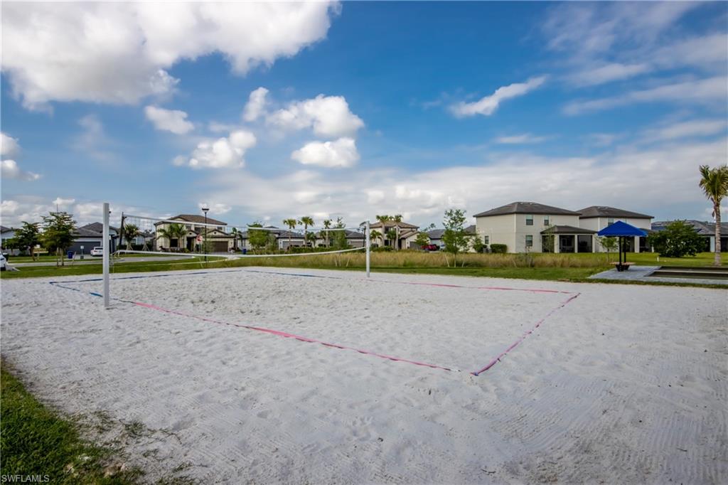 View of community with a residential view, volleyball court, and a yard