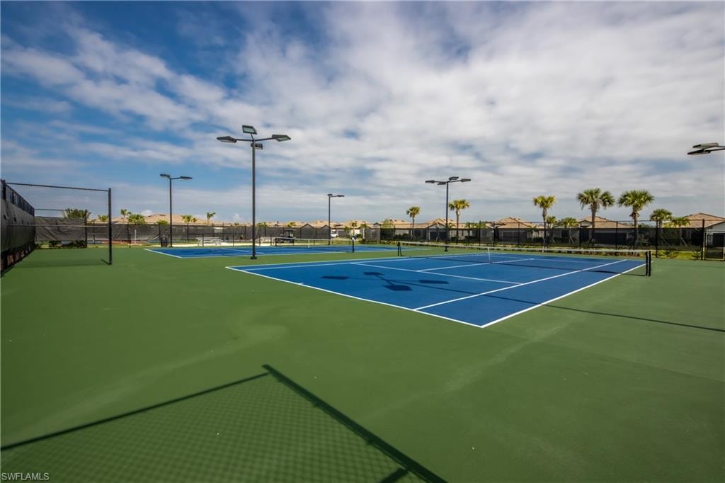 View of tennis court featuring a residential view