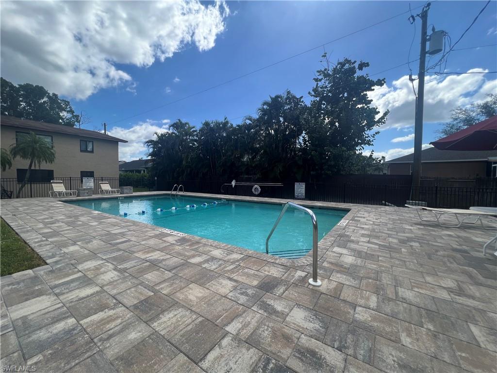 Community pool with a patio