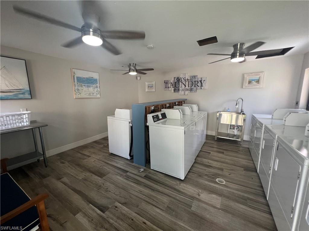 Communal laundry room featuring washer and clothes dryer and ceiling fan