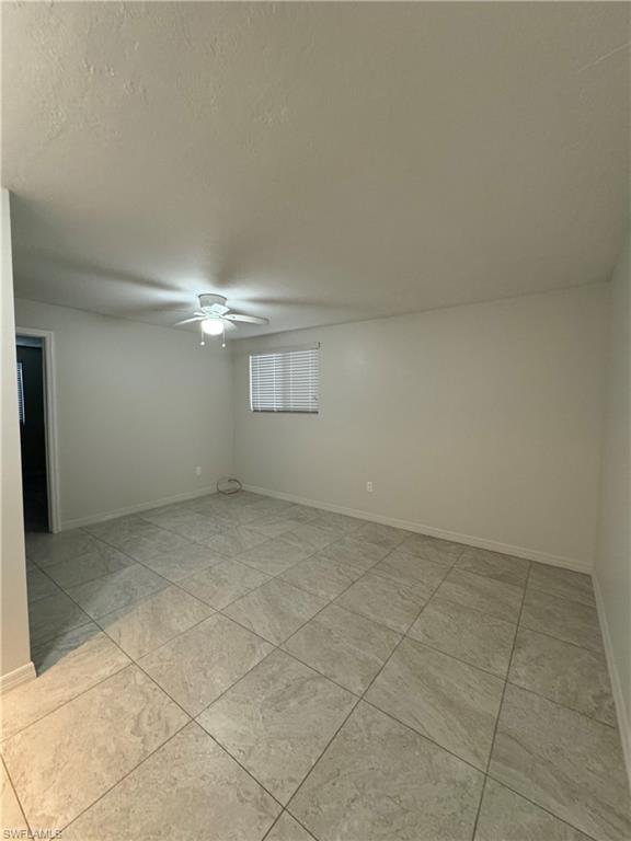 Spare room featuring ceiling fan and a textured ceiling