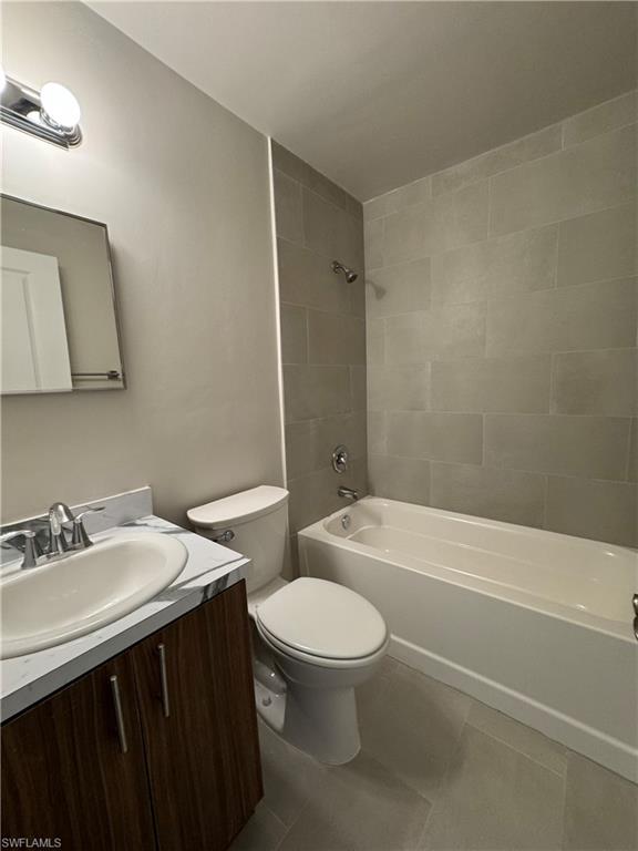 Full bath featuring shower / washtub combination, vanity, and tile patterned flooring
