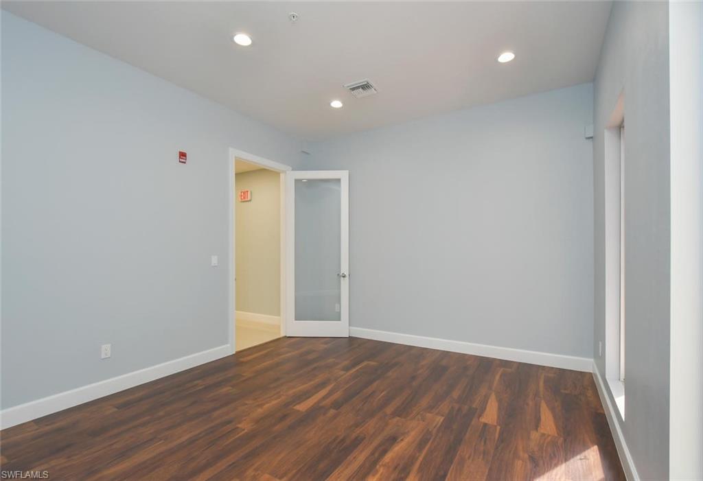 Unfurnished room with dark wood-type flooring, recessed lighting, and french doors