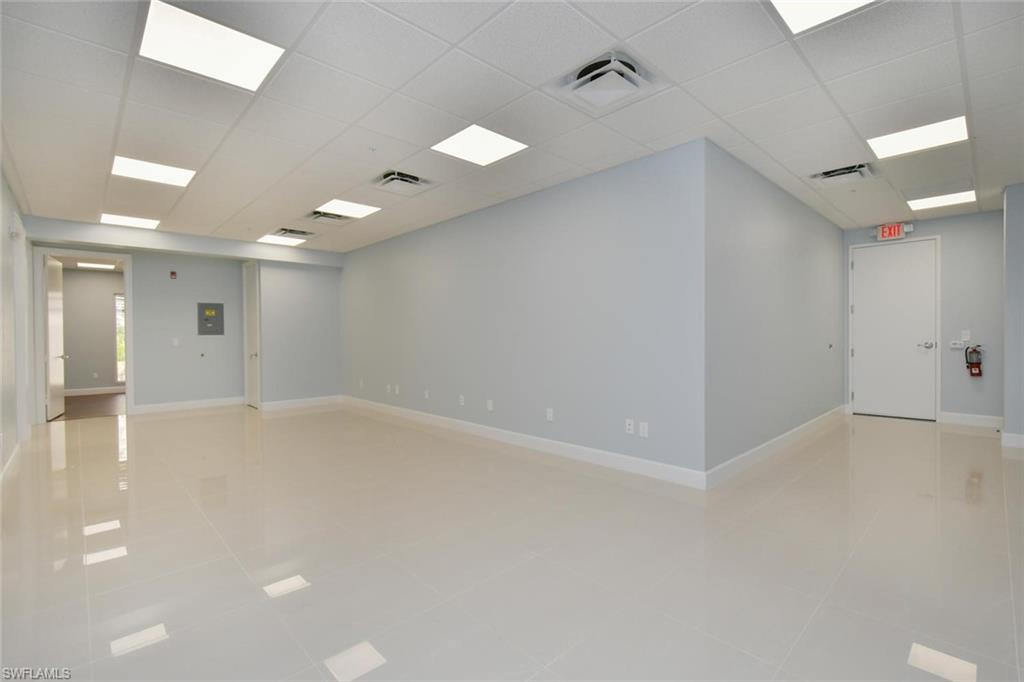 Unfurnished room with a paneled ceiling and light tile patterned floors