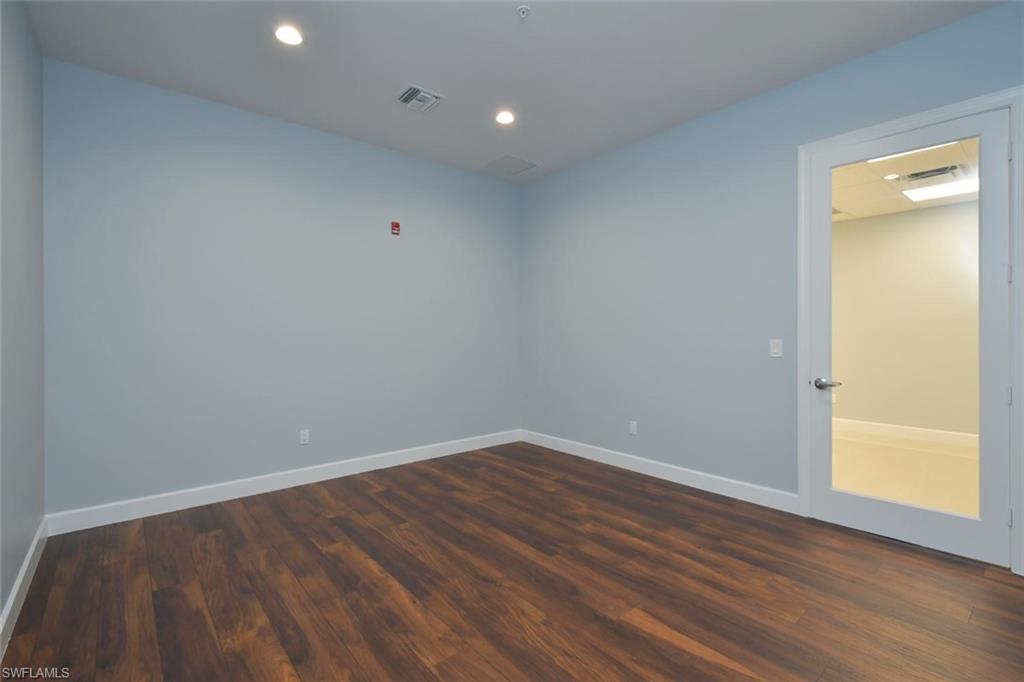 Spare room with dark wood finished floors and recessed lighting