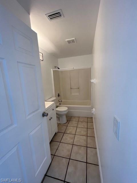 Full bathroom featuring light tile patterned floors, vanity, and shower / washtub combination