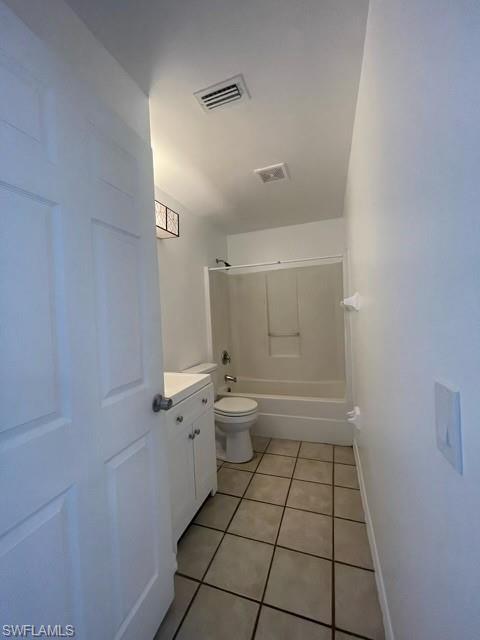 Full bath featuring light tile patterned flooring, vanity, and tub / shower combination
