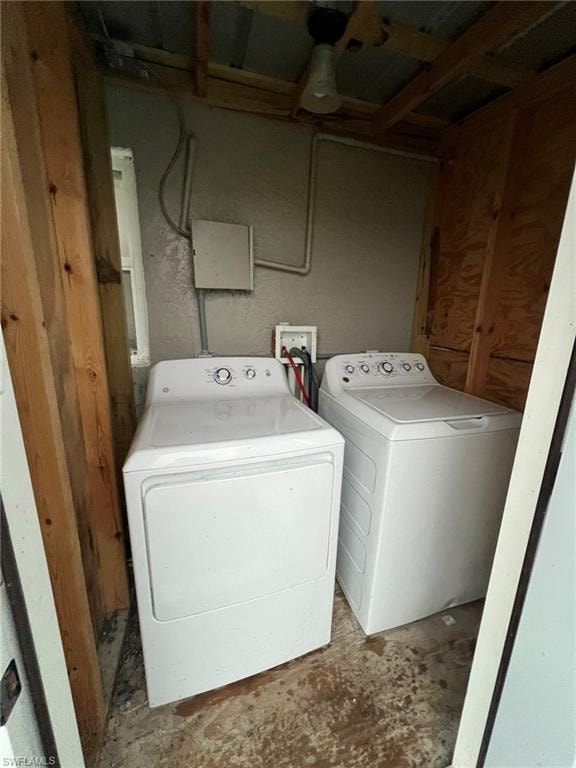 Washroom featuring washing machine and dryer and concrete floors