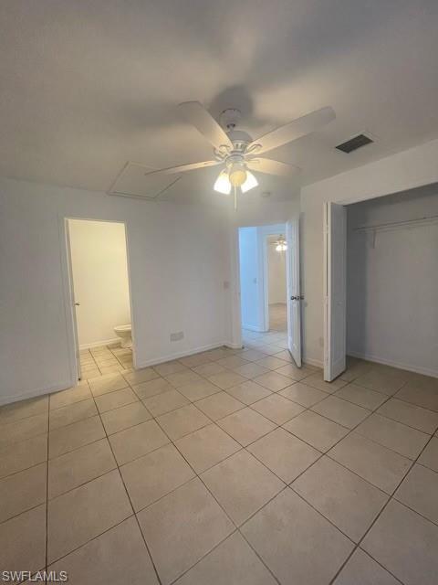 Unfurnished bedroom with a closet, a ceiling fan, and light tile patterned floors