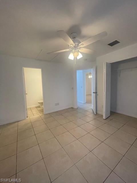 Unfurnished bedroom with a ceiling fan, a closet, and light tile patterned flooring