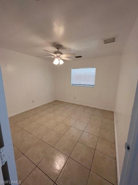 Unfurnished room featuring light tile patterned floors and ceiling fan