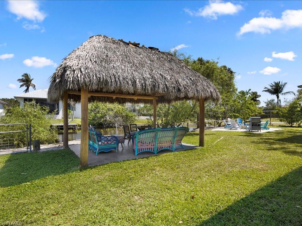View of property's community featuring a patio area, a gazebo, and a lawn