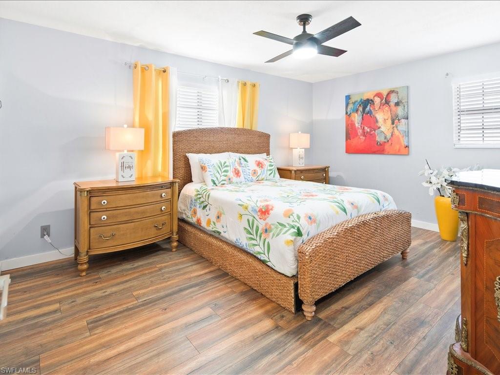 Bedroom with hardwood / wood-style flooring and ceiling fan