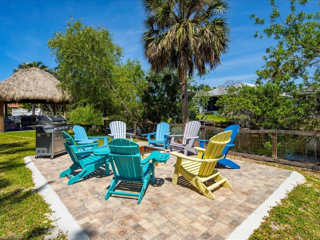 View of patio featuring grilling area, a gazebo, and a fire pit