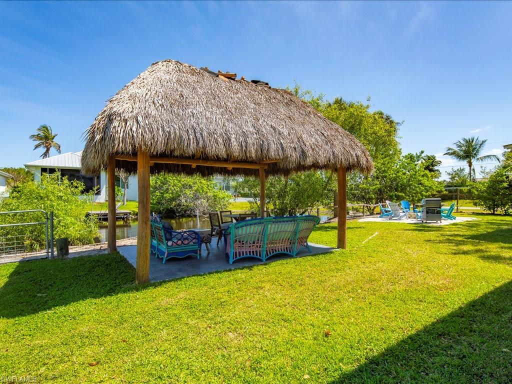 View of property's community featuring a patio, a gazebo, an outdoor hangout area, and a yard