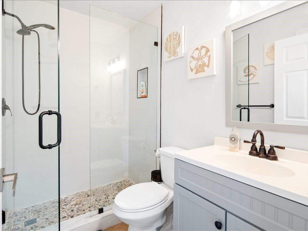 Full bath with a stall shower and vanity
