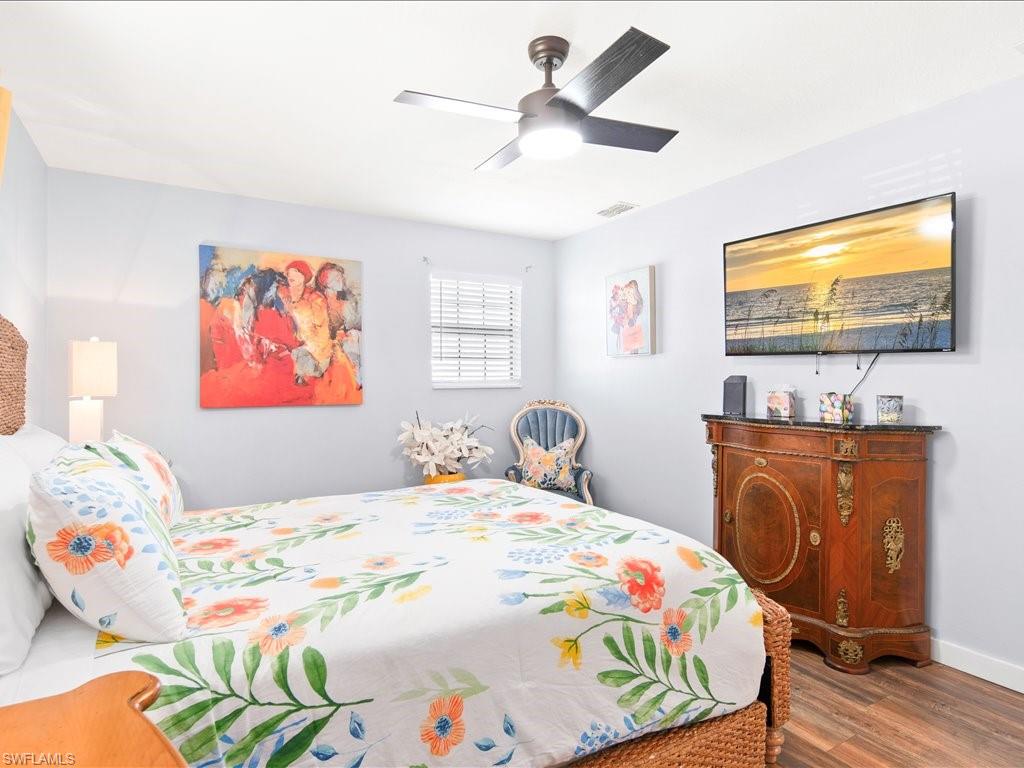 Bedroom featuring wood finished floors and a ceiling fan