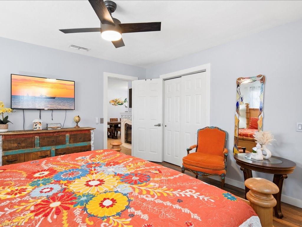 Bedroom featuring ceiling fan, wood finished floors, and a closet