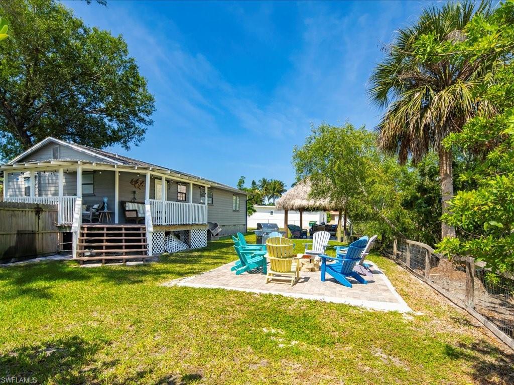 Back of house featuring a fenced backyard, a patio, and stairs