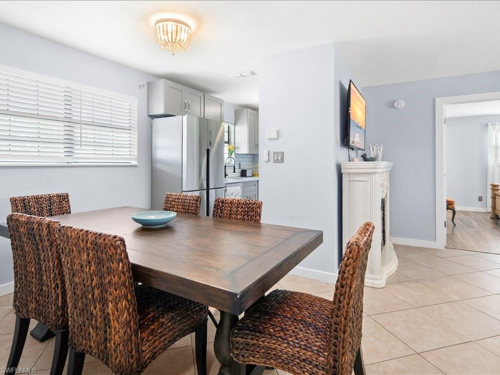 Dining room featuring light tile patterned flooring and baseboards