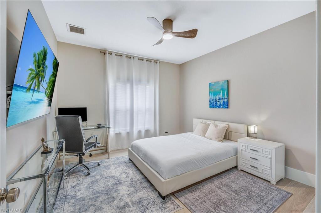 Bedroom featuring a desk, wood finished floors, and ceiling fan