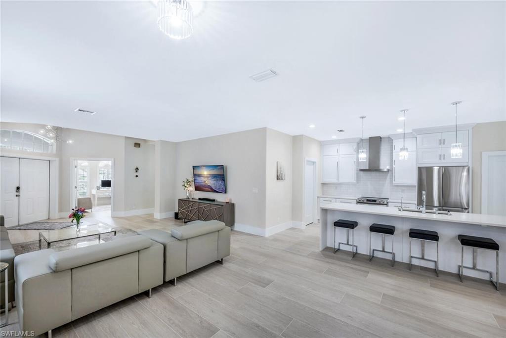 Living room featuring light wood-type flooring and recessed lighting