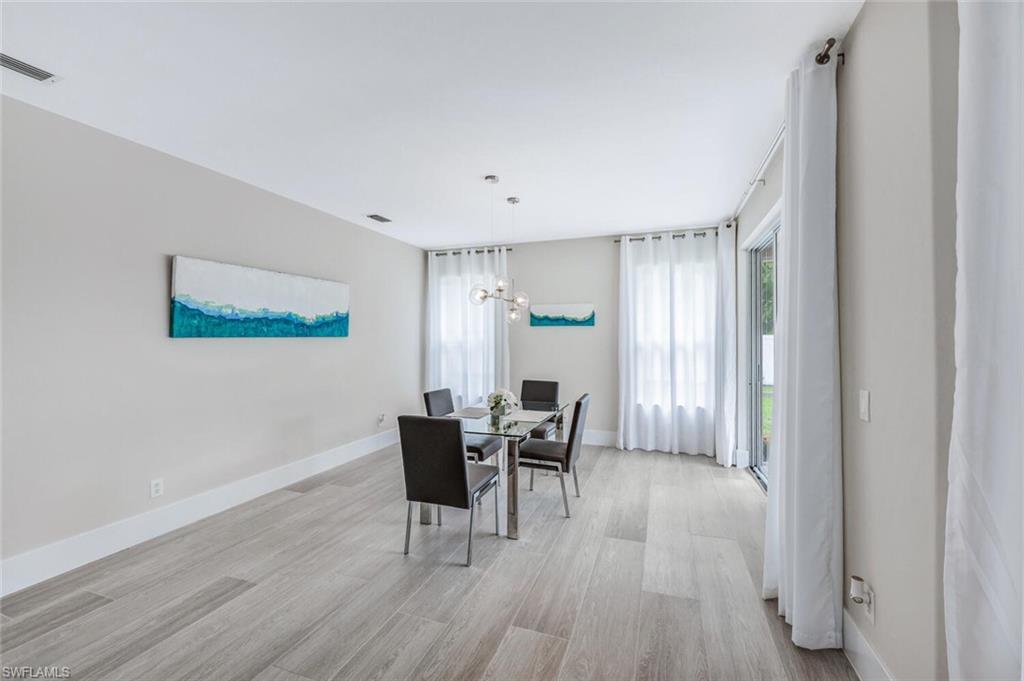 Dining space featuring light wood-style floors and a chandelier