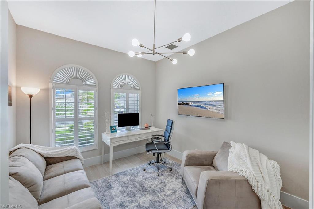 Office area featuring wood finished floors and a chandelier